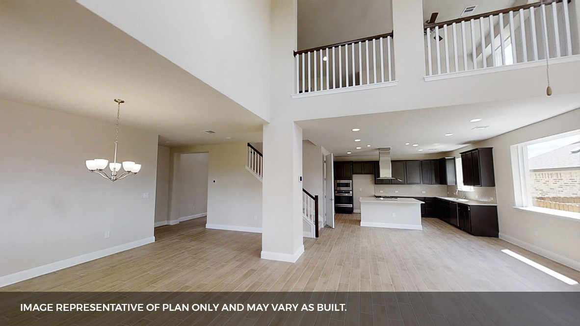 516 Prairie Wind Drive Leander, TX 78641 - Photo 10 of 40 a open kitchen with stainless steel appliances kitchen island granite countertop a refrigerator a stove a sink dishwasher and white cabinets with wooden floor