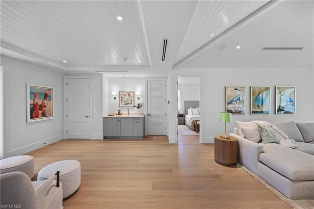 a living room with furniture and a potted plant