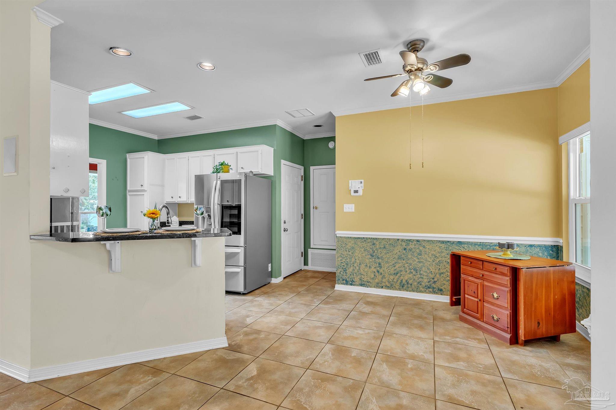 11705 Cabot Street Cantonment, FL 32533 - Photo 14 of 36 a open kitchen with stainless steel appliances granite countertop a refrigerator and a sink