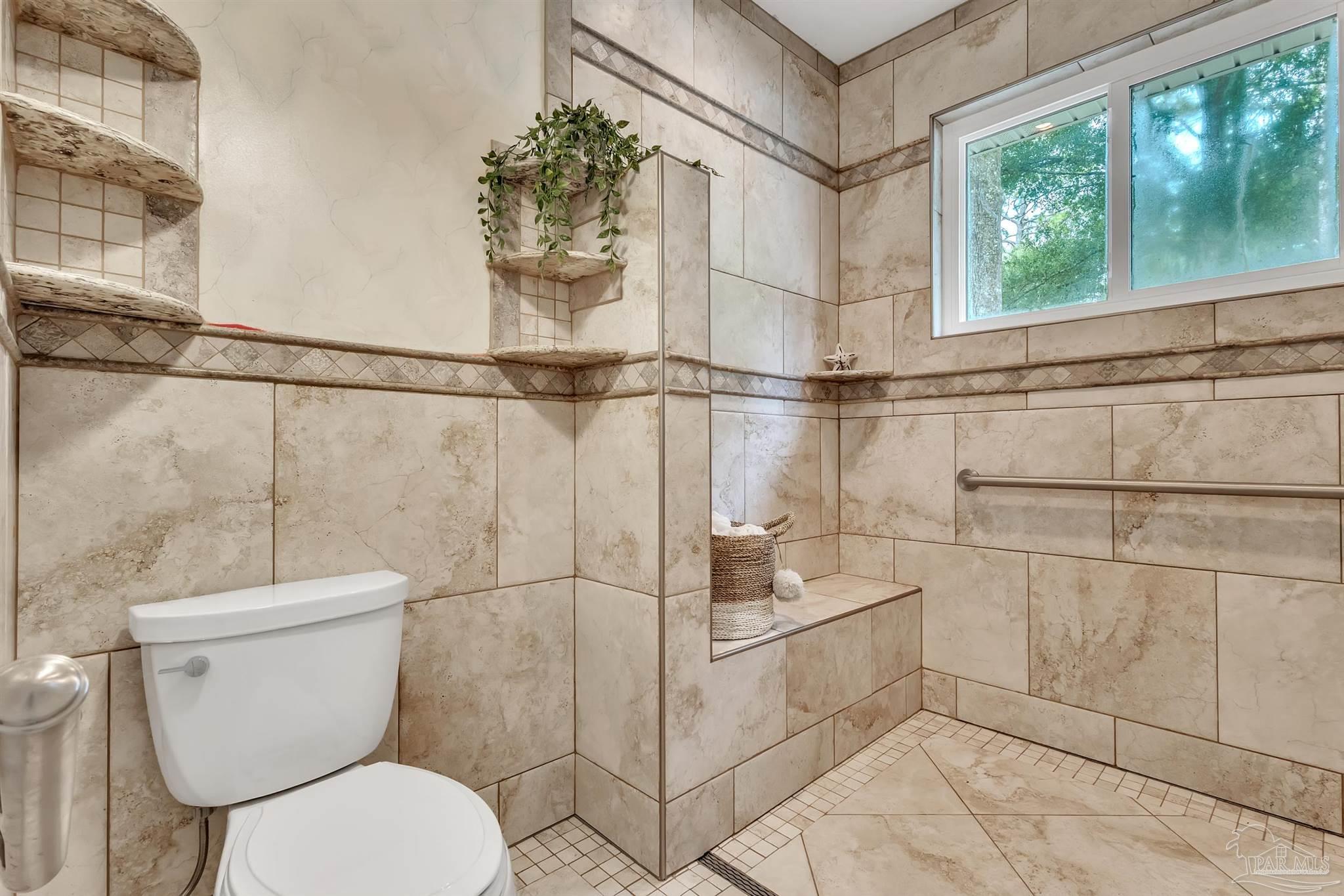 11705 Cabot Street Cantonment, FL 32533 - Photo 23 of 36 a bathroom with a toilet and a shower