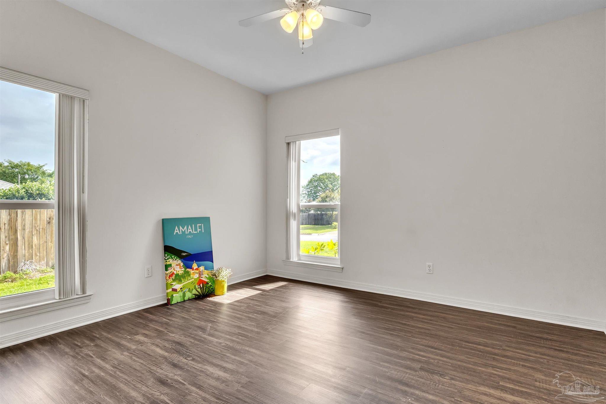 11705 Cabot Street Cantonment, FL 32533 - Photo 26 of 36 a view of room with window and wooden floor