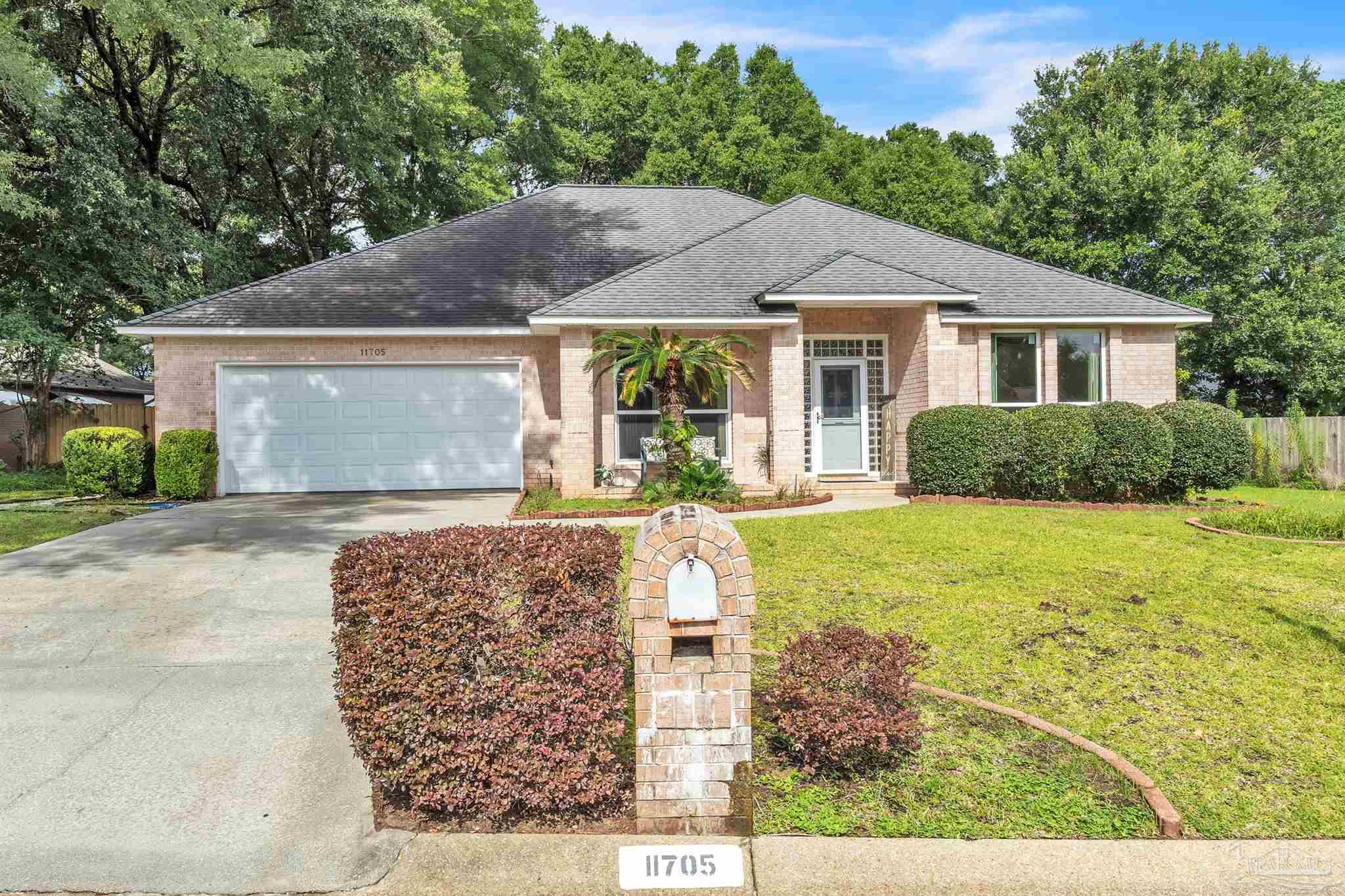 11705 Cabot Street Cantonment, FL 32533 - Photo 35 of 36 a front view of a house with garden