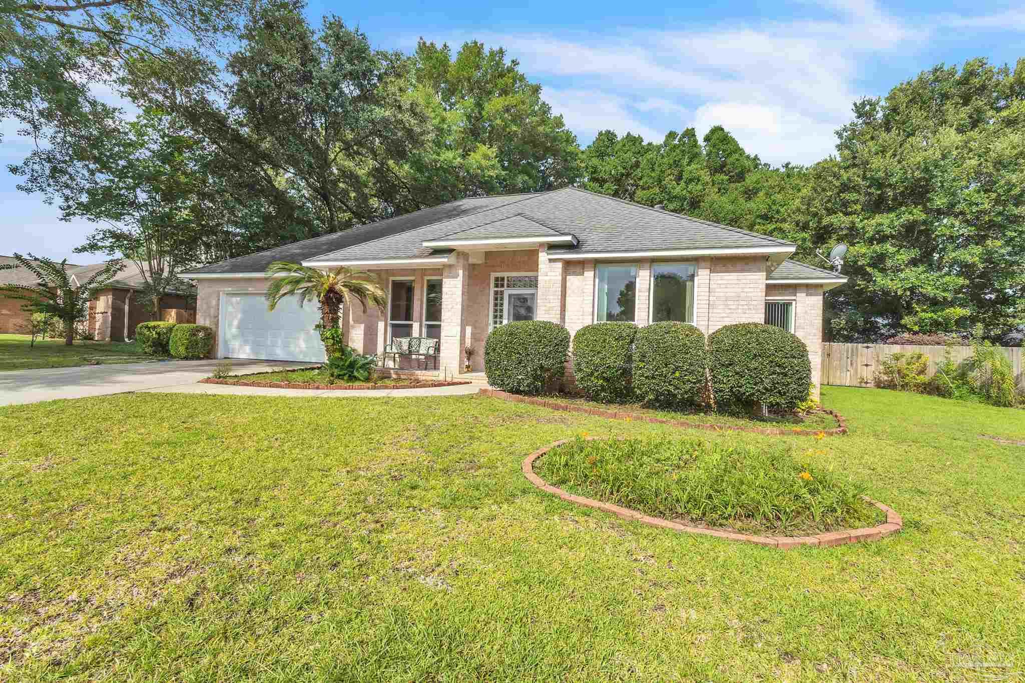11705 Cabot Street Cantonment, FL 32533 - Photo 36 of 36 a view of a house with a yard and plants