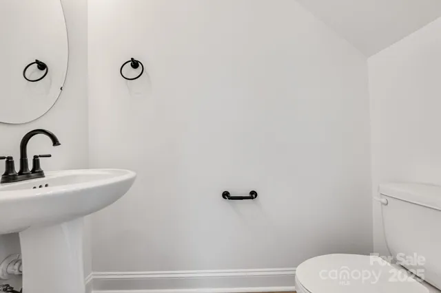 a bathroom with a sink mirror and toilet