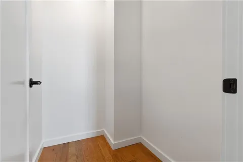 a view of a room with wooden floor