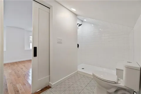 a bathroom with a toilet and a shower