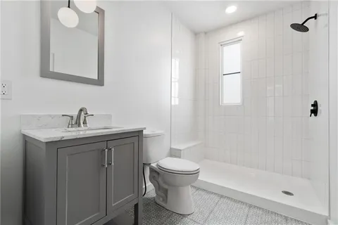 a bathroom with a sink toilet and shower