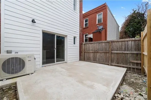 a view of backyard and wooden fence