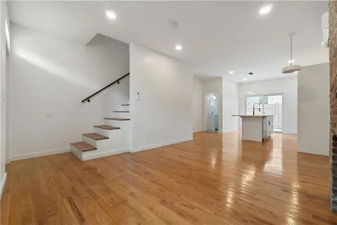 a view of an empty room and wooden floor