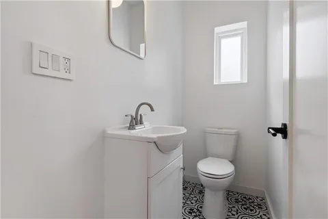 a bathroom with a toilet a sink and mirror