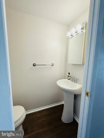 a bathroom with a sink toilet and a mirror