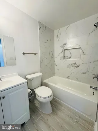 a bathroom with a toilet and a bathtub
