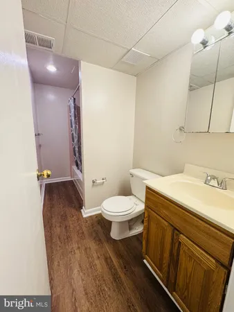 a wooden bench sitting in front of a building