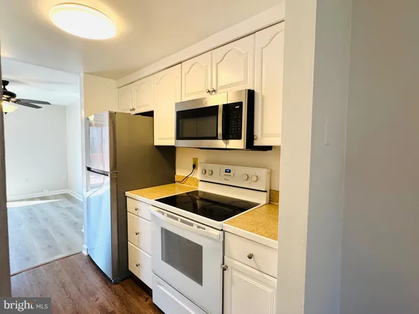 a kitchen with stainless steel appliances a stove microwave and refrigerator