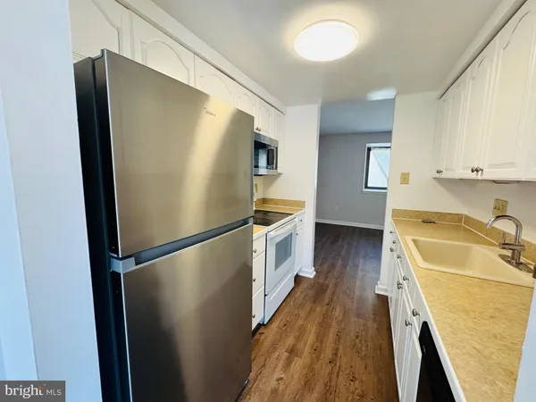 a kitchen with a refrigerator a sink and dishwasher