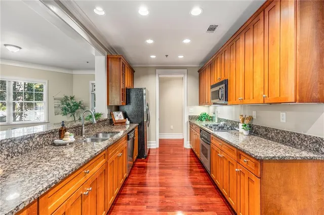 a large kitchen with kitchen island granite countertop a large counter top and sink