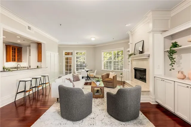 a living room with fireplace furniture and a large window