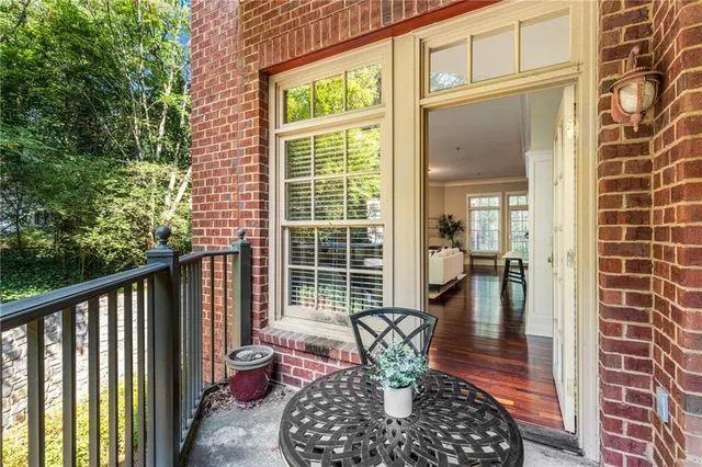 a living room with furniture large window and wooden floor