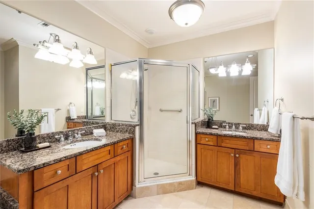 a bathroom with a granite countertop sink a mirror a vanity and a bathtub