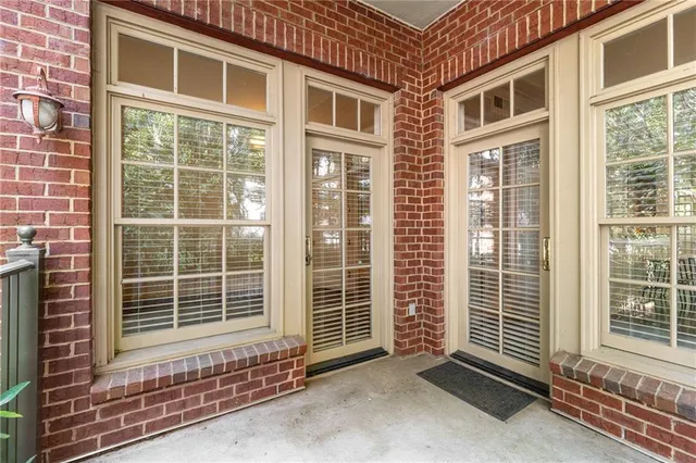 a view of a balcony with floor to ceiling window and wooden fence