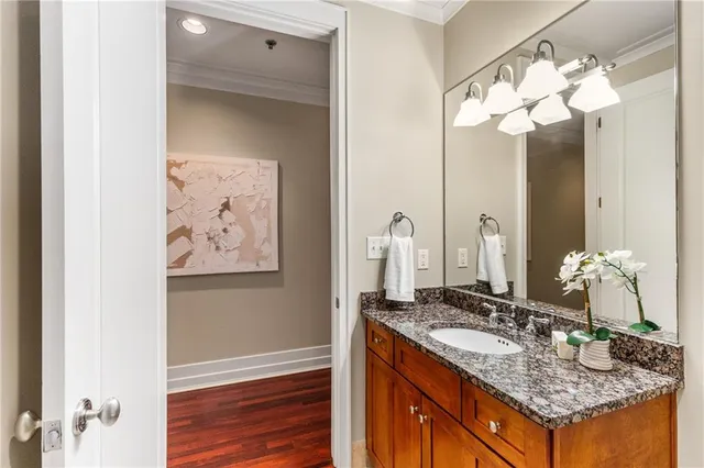 a view of a hallway with wooden floor and furniture