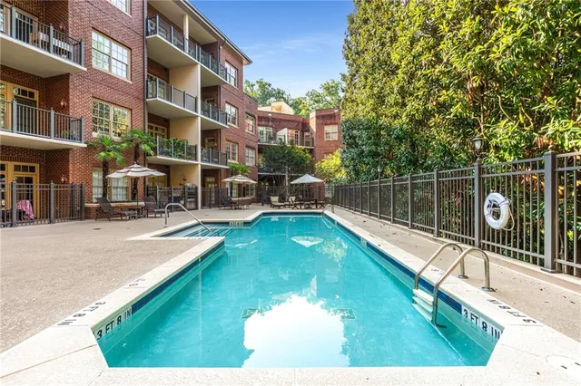 a swimming pool with outdoor seating and yard
