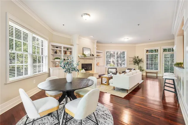 a living room with fireplace furniture and a table