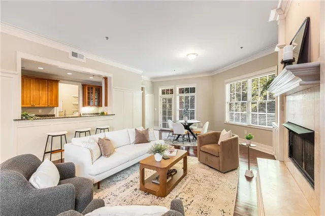 a living room with furniture wooden floor and a fireplace