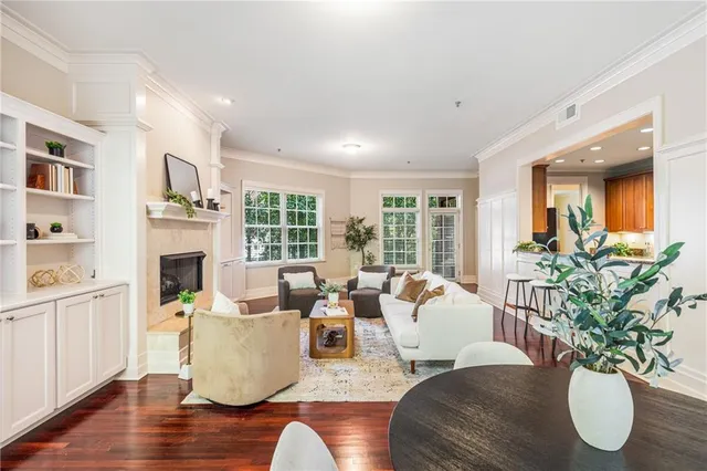a living room with fireplace furniture and a potted plant