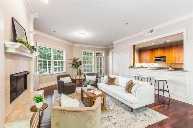 a living room with furniture a fireplace and a flat screen tv