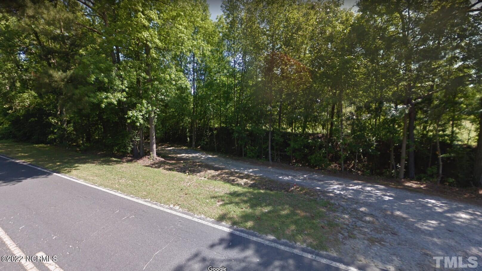 1-2 Grady Road Clinton, NC 28328 - Photo 2 of 4 a view of a backyard with trees