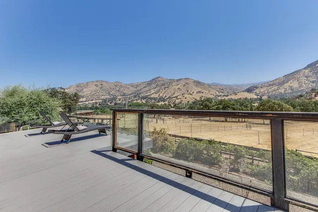 a view of a terrace with glass top table and chair