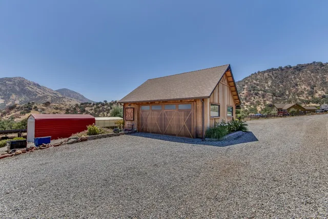a view of house with yard and car parked