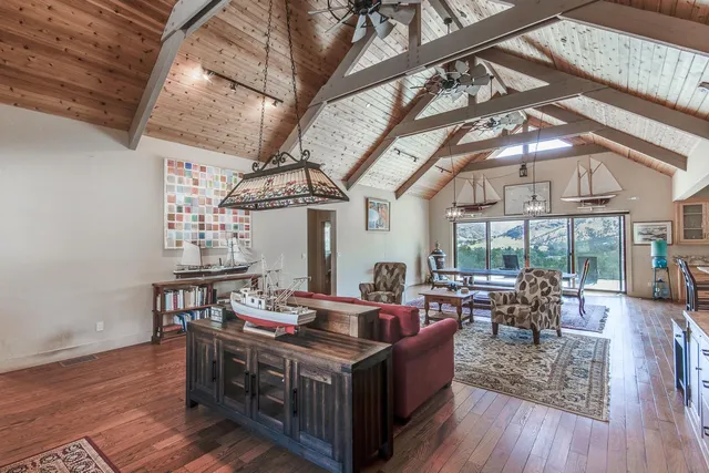a living room with furniture a wooden floor and a chandelier