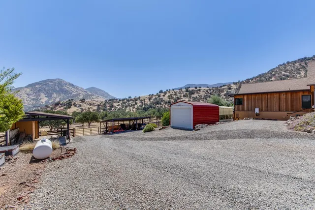 a view of a house with a yard and a sitting area