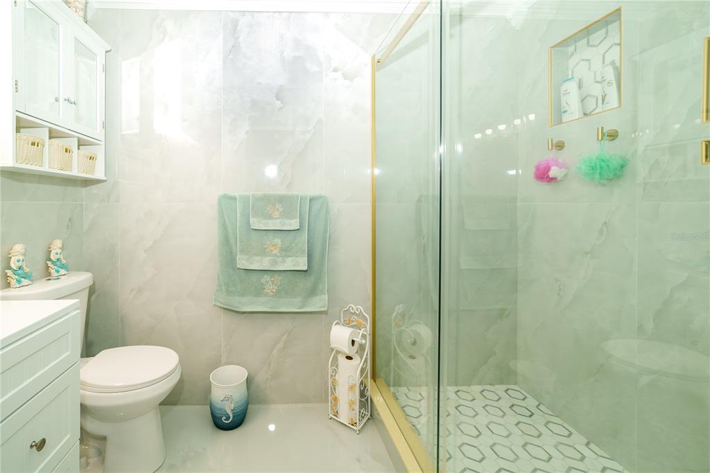 Undisclosed Address Spring Hill, FL 34609 - Photo 20 of 32 a bathroom with a toilet sink and shower