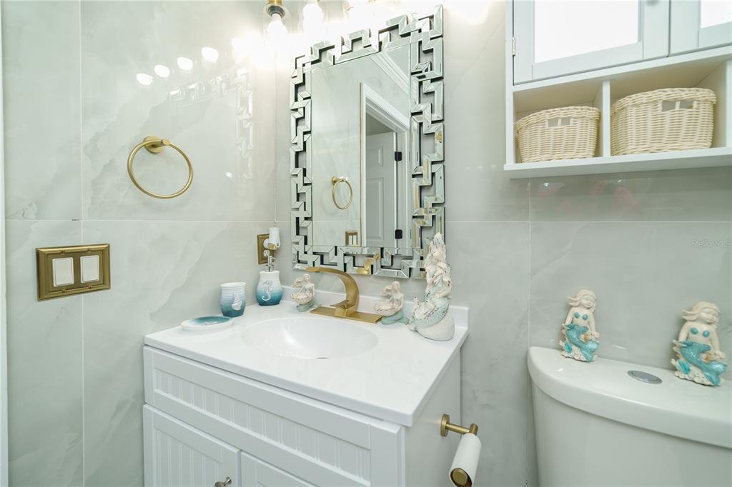 Undisclosed Address Spring Hill, FL 34609 - Photo 21 of 32 a bathroom with a sink and a mirror