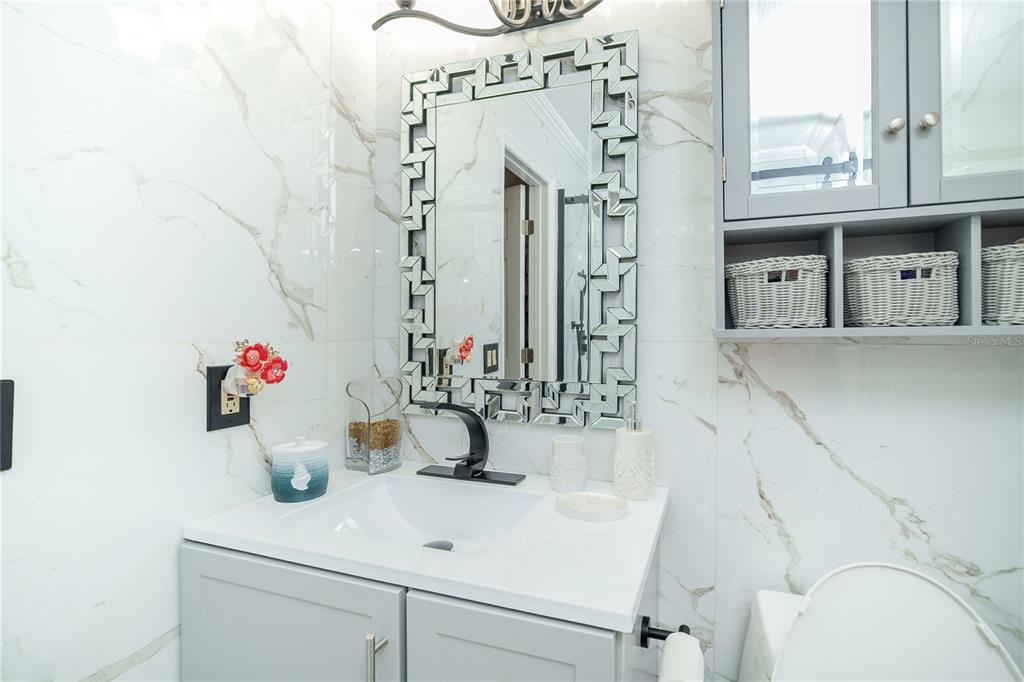 Undisclosed Address Spring Hill, FL 34609 - Photo 23 of 32 a bathroom with a sink and a mirror