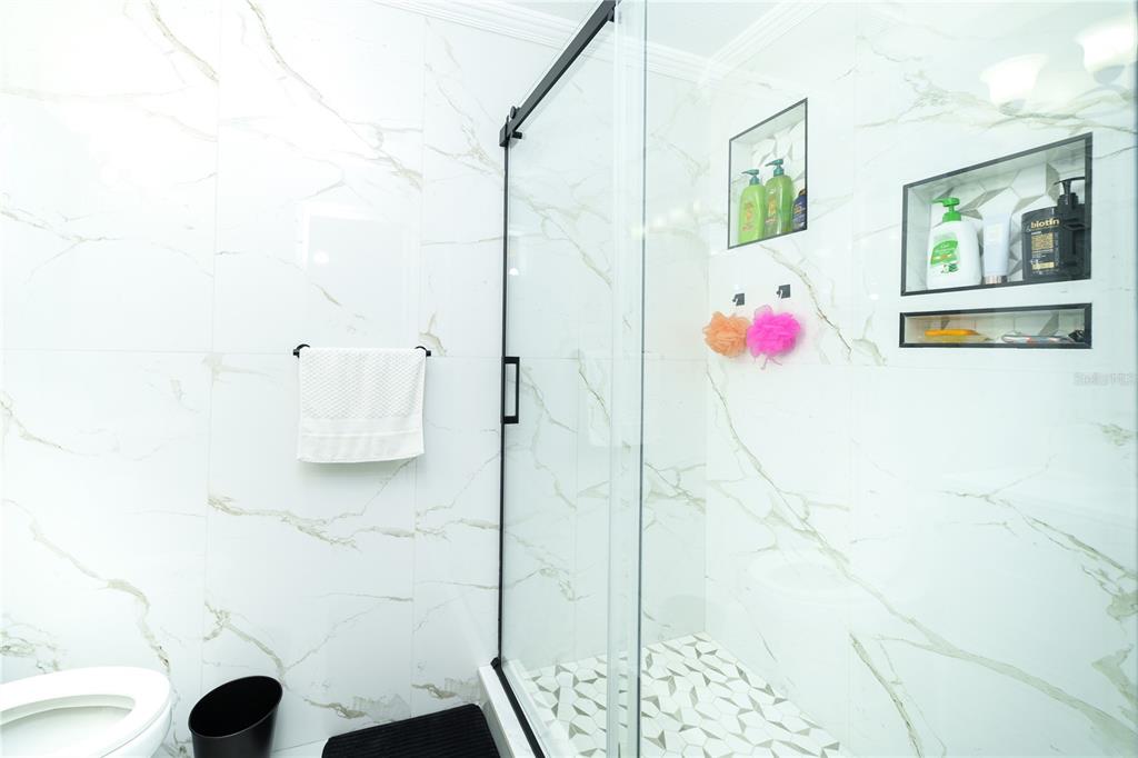 Undisclosed Address Spring Hill, FL 34609 - Photo 24 of 32 a bathroom with a bathtub and shower