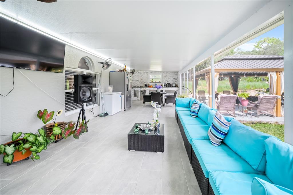 Undisclosed Address Spring Hill, FL 34609 - Photo 28 of 32 a living room with furniture fireplace and a large window