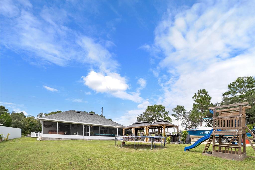 Undisclosed Address Spring Hill, FL 34609 - Photo 31 of 32 a front view of house with yard and entertaining space