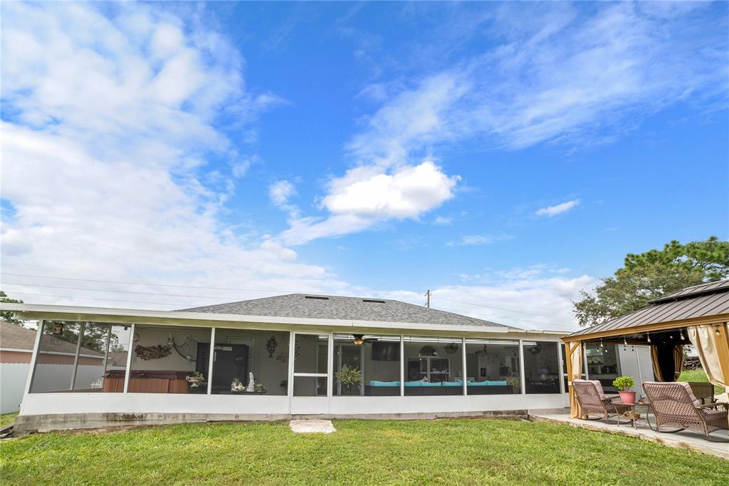 Undisclosed Address Spring Hill, FL 34609 - Photo 32 of 32 a view of a house with a large window and a yard
