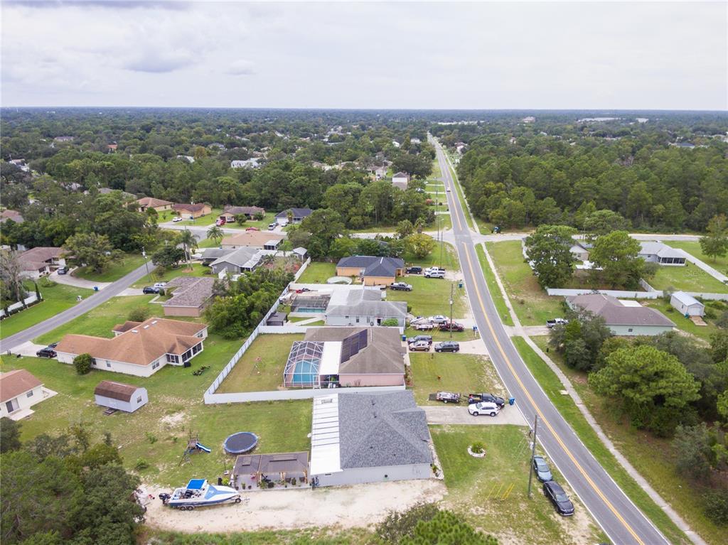 Undisclosed Address Spring Hill, FL 34609 - Photo 5 of 32 an aerial view of residential houses with outdoor space and parking