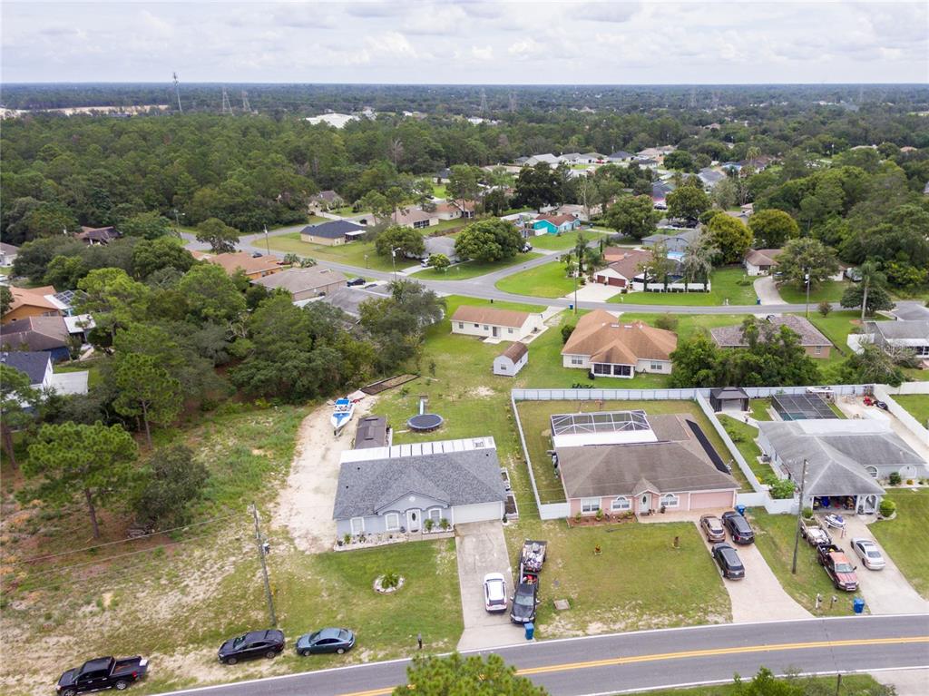 Undisclosed Address Spring Hill, FL 34609 - Photo 6 of 32 an aerial view of residential houses with outdoor space and parking