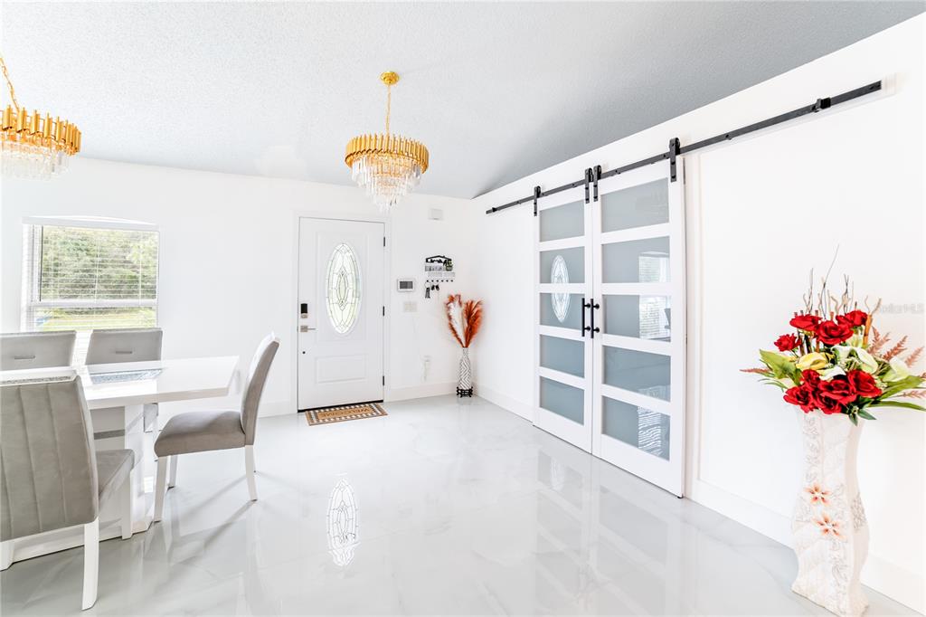 Undisclosed Address Spring Hill, FL 34609 - Photo 9 of 32 a view of a livingroom with furniture and a book shelf