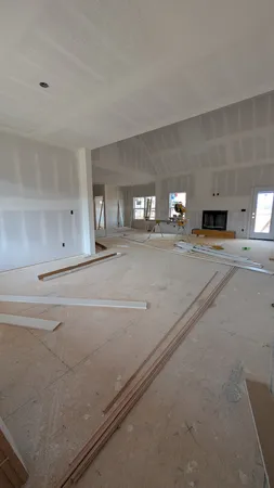 a large white kitchen with stainless steel appliances