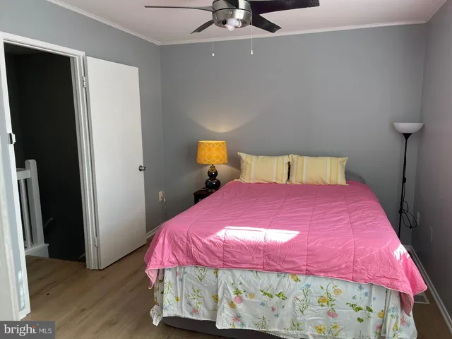 a bedroom with a bed and a mirror