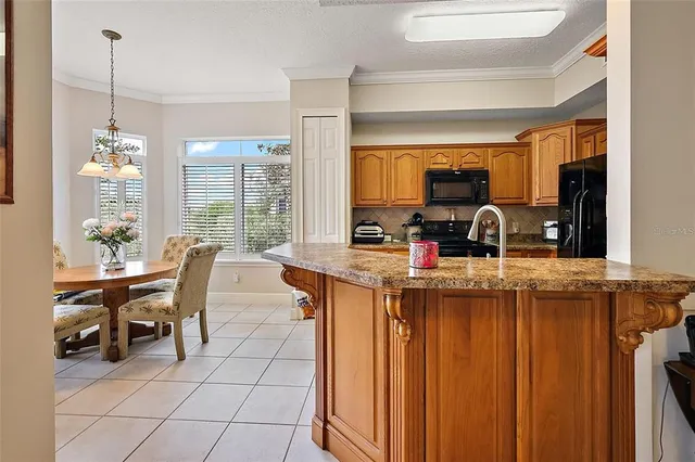 a kitchen with a table chairs and a view of living room