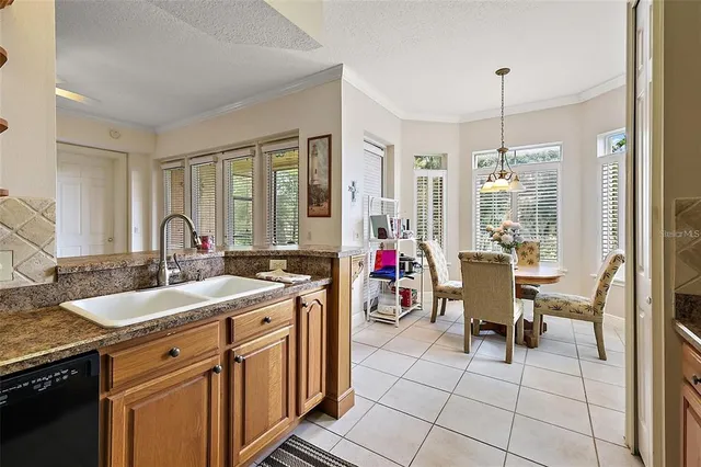 a view of a kitchen sink dining table and chairs