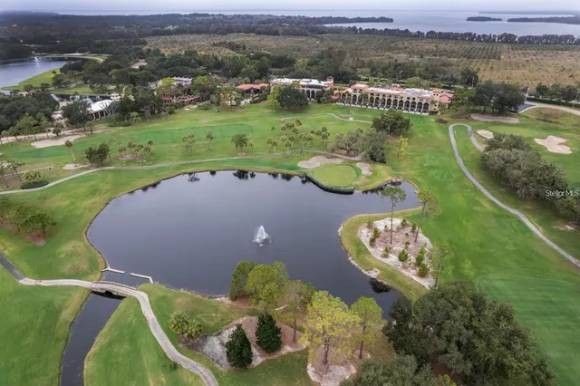 an aerial view of a house with a garden and lake view